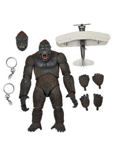 "Figura King Kong de NECA junto con accesorios: cadenas, cabezas intercambiables, manos adicionales y avión biplano."