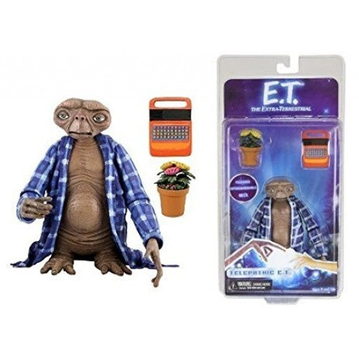 “Figura E.T. con bata, maceta y máquina de escribir naranja.”